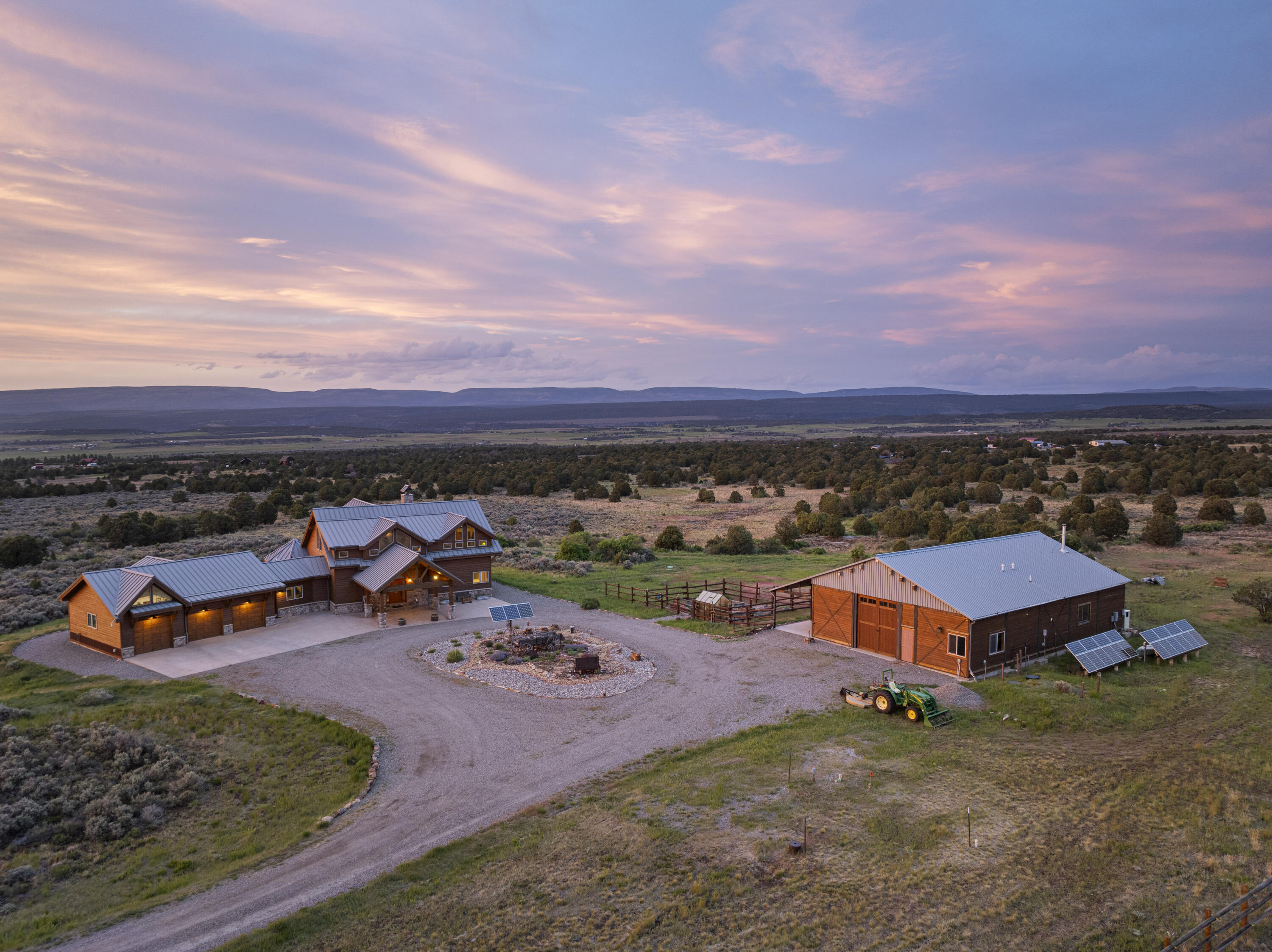3100 South County Road Norwood, CO 81423 - Photo 3 of 44 an aerial view of a house with a garden and lake view