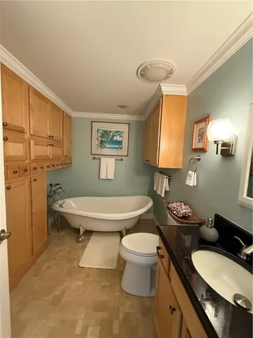 a bathroom with a granite countertop toilet sink and mirror