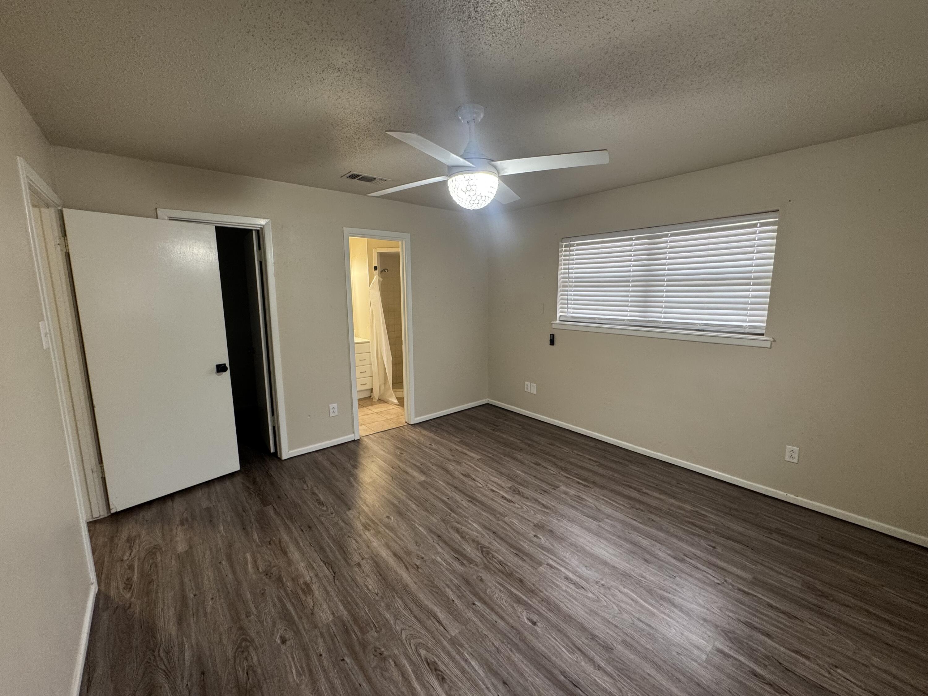 601 Chicago Avenue Lubbock, TX 79416 - Photo 11 of 12 an empty room with wooden floor and windows