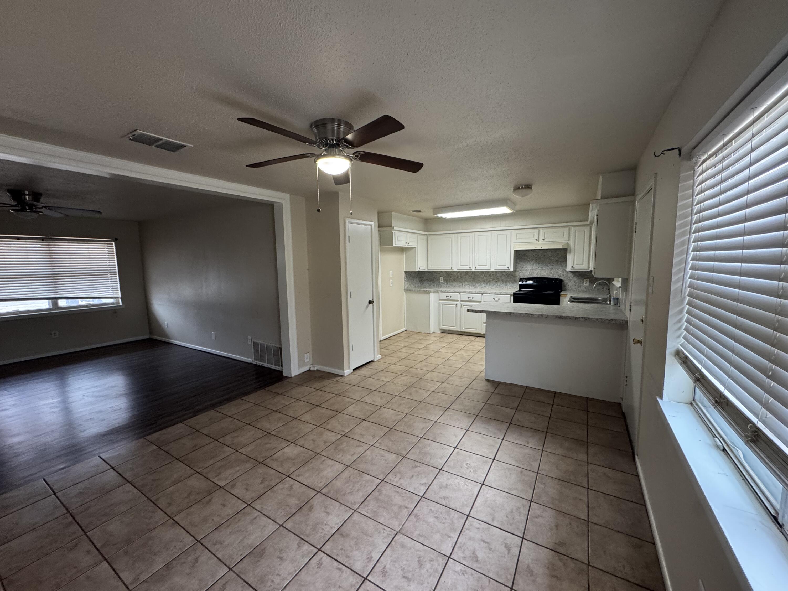 601 Chicago Avenue Lubbock, TX 79416 - Photo 4 of 12 a kitchen with granite countertop a stove a sink and a refrigerator