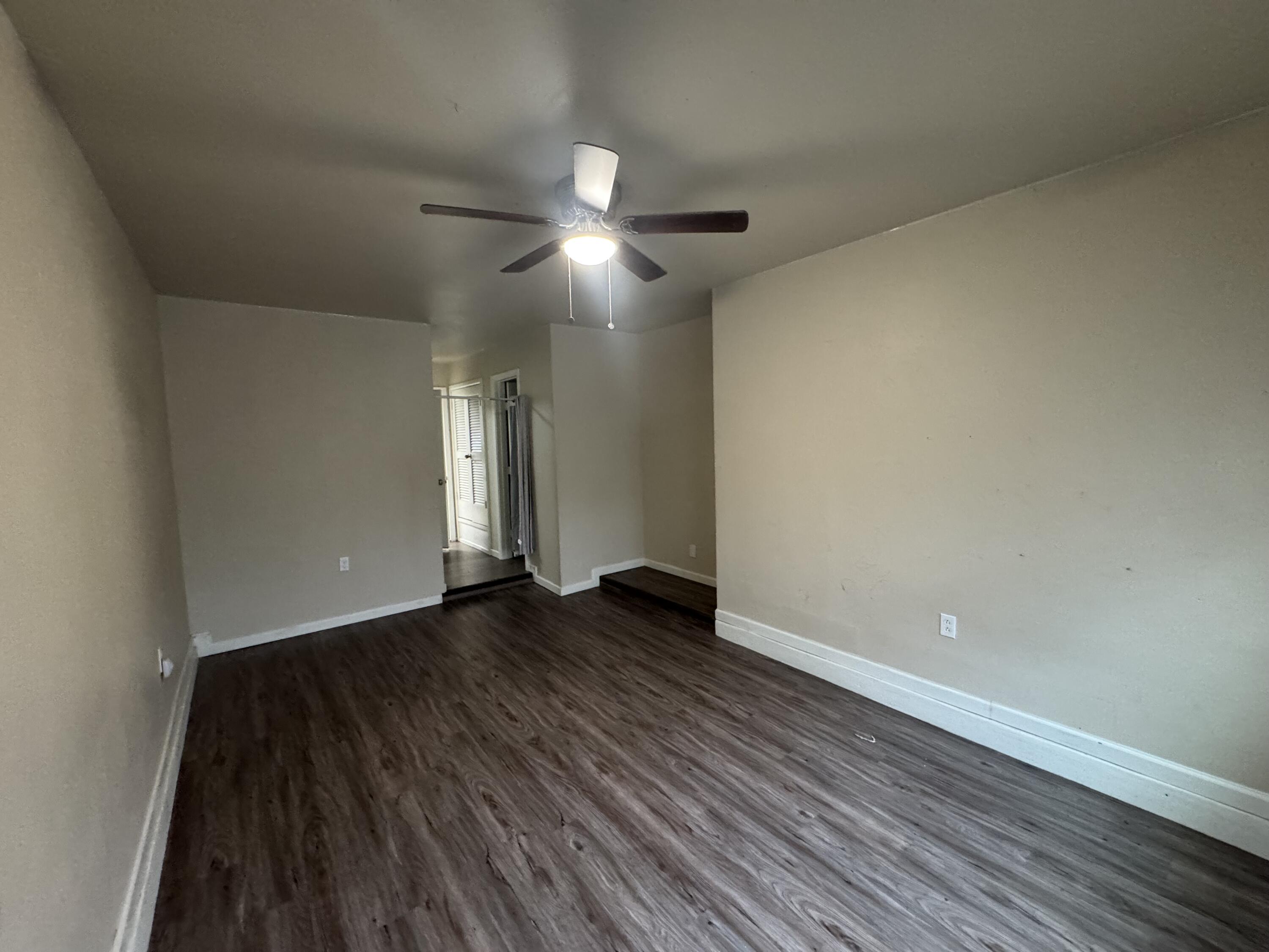 601 Chicago Avenue Lubbock, TX 79416 - Photo 6 of 12 a view of an empty room and wooden floor