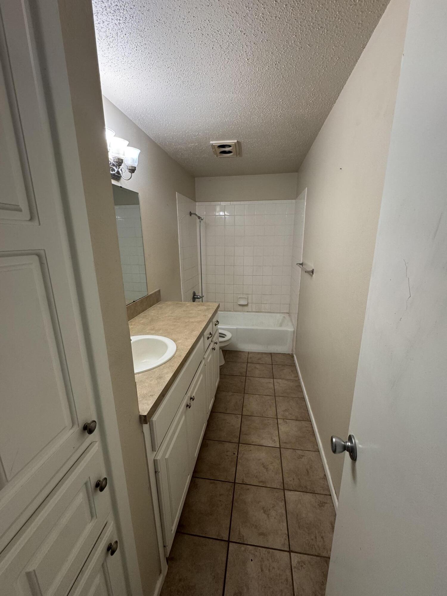 601 Chicago Avenue Lubbock, TX 79416 - Photo 8 of 12 a bathroom with a sink a toilet and a shower