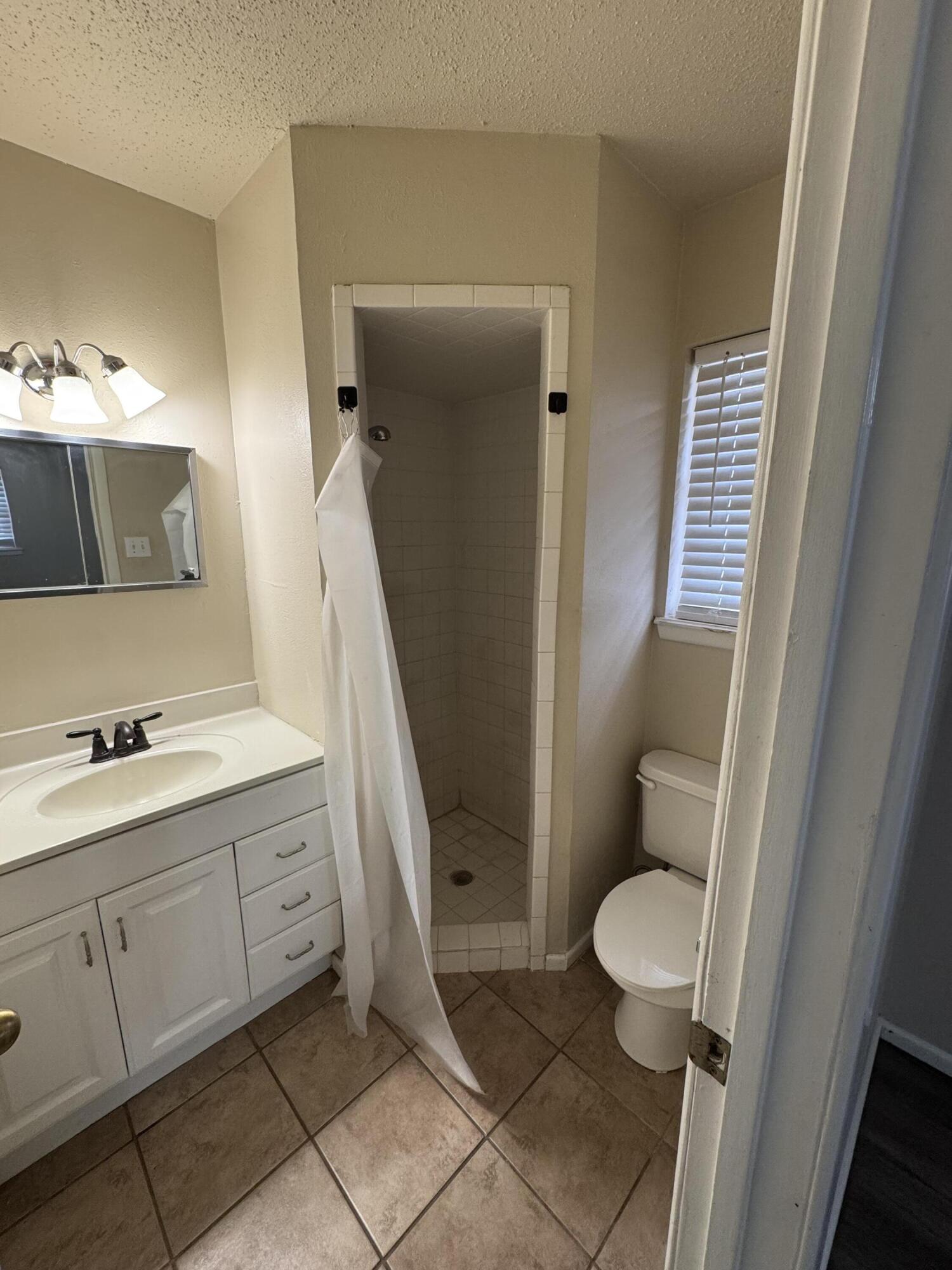601 Chicago Avenue Lubbock, TX 79416 - Photo 10 of 12 a bathroom with a sink and a mirror