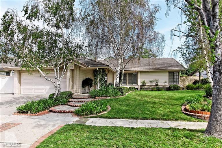 2704 Bitternut Circle Simi Valley, CA 93065 - Photo 1 of 25 a front view of a house with a yard and potted plants