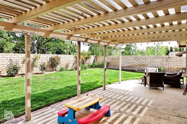 2704 Bitternut Circle Simi Valley, CA 93065 - Photo 17 of 25 a view of a patio with table and chairs potted plants with wooden floor and fence