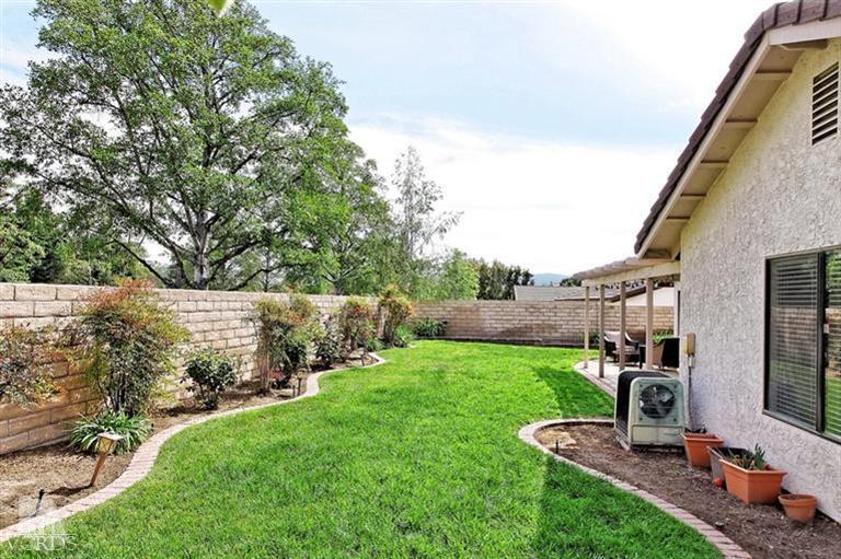 2704 Bitternut Circle Simi Valley, CA 93065 - Photo 20 of 25 a view of a backyard with couches plants and large trees