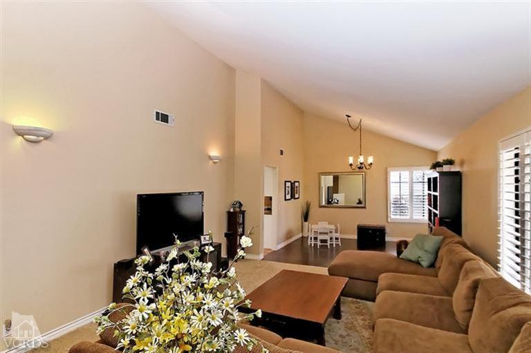 2704 Bitternut Circle Simi Valley, CA 93065 - Photo 3 of 25 a living room with furniture a flat screen tv and a large window