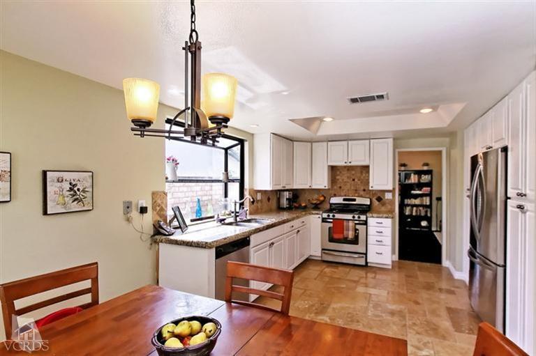 2704 Bitternut Circle Simi Valley, CA 93065 - Photo 6 of 25 a room with stainless steel appliances kitchen island granite countertop a refrigerator a stove a sink and a stove with wooden floor