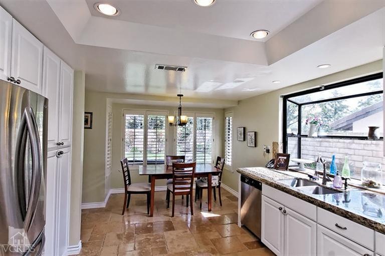 2704 Bitternut Circle Simi Valley, CA 93065 - Photo 7 of 25 a large kitchen with a table and chairs