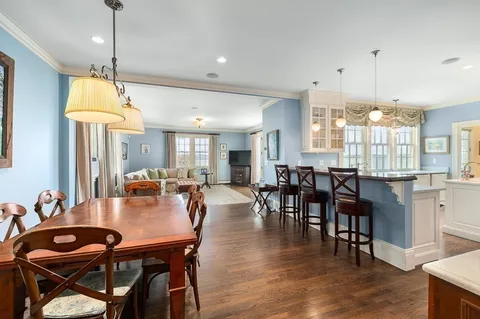 a dining room with furniture window and wooden floor