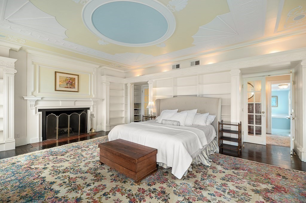 66 Ocean Street Nahant, MA 01908 - Photo 18 of 40 a spacious bedroom with a large bed and a fireplace