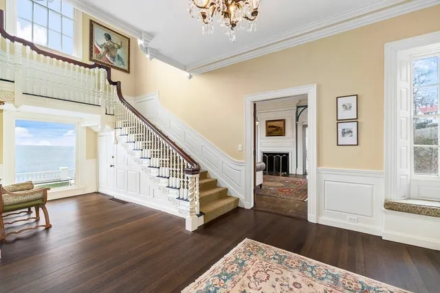 a view of entryway and hall with wooden floor