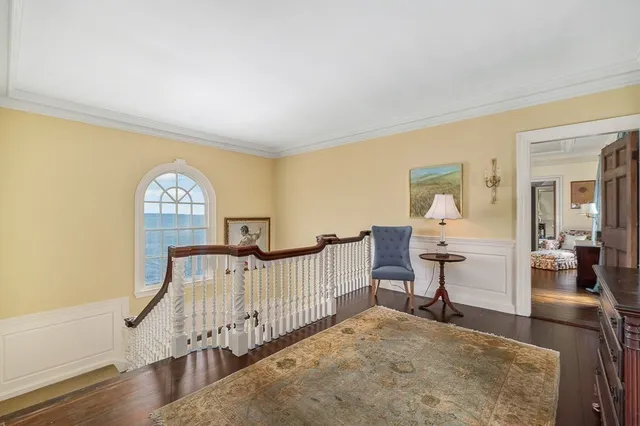 a view of a livingroom with wooden floor and a bookshelf