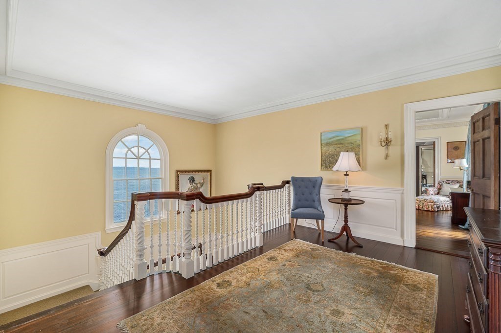 66 Ocean Street Nahant, MA 01908 - Photo 25 of 40 a view of a livingroom with wooden floor and a bookshelf