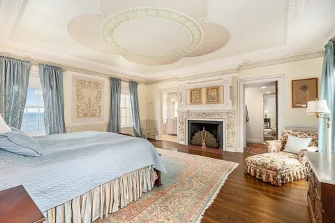 a bedroom with a bed and a fireplace