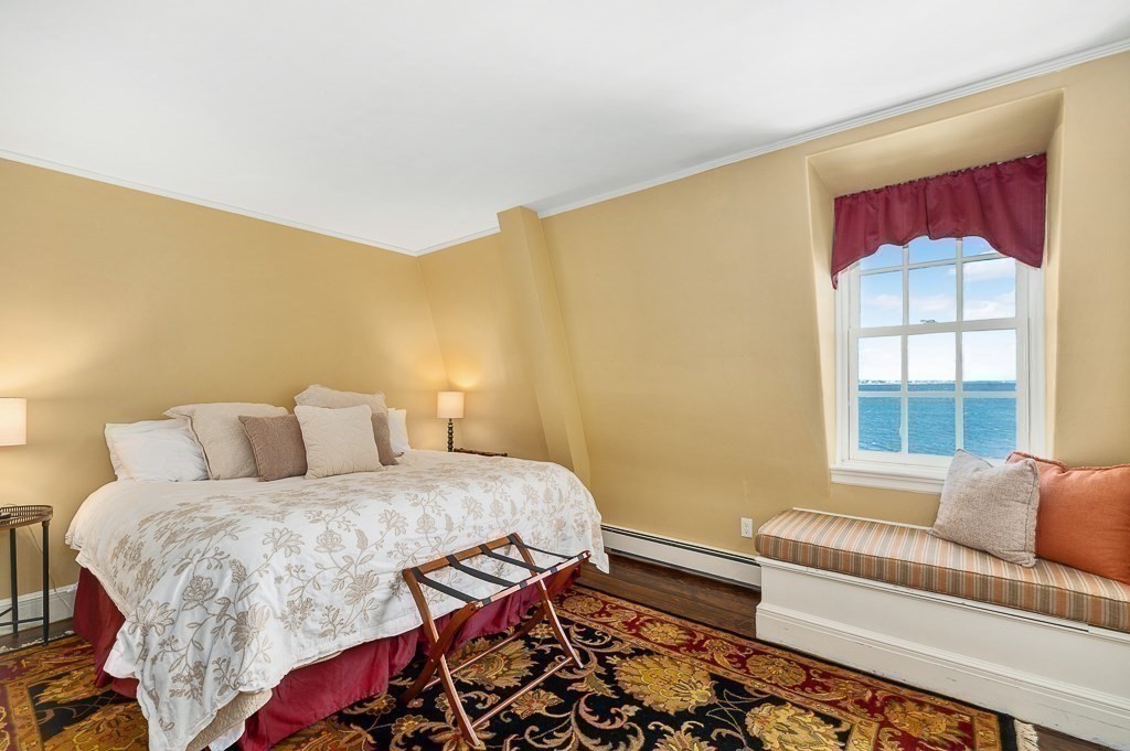 66 Ocean Street Nahant, MA 01908 - Photo 27 of 40 a bedroom with a bed and wooden floor
