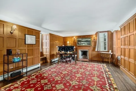 a living room with furniture fireplace and flat screen tv