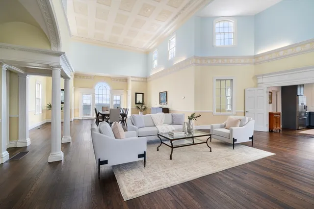 a living room with fireplace furniture and a wooden floor