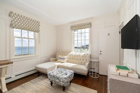 a living room with furniture wooden floor and a flat screen tv