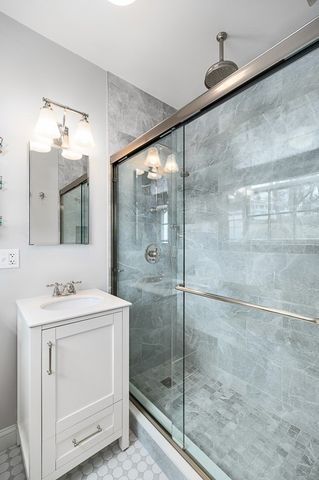 a bathroom with a shower sink and mirror