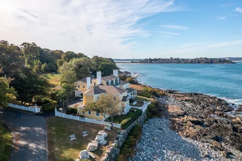 an aerial view of a house with a yard