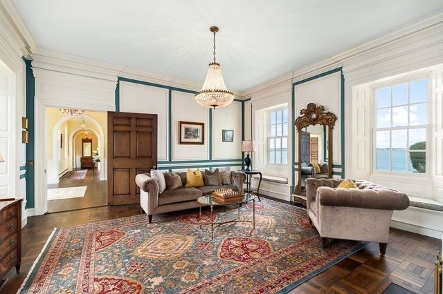 a living room with furniture and a chandelier