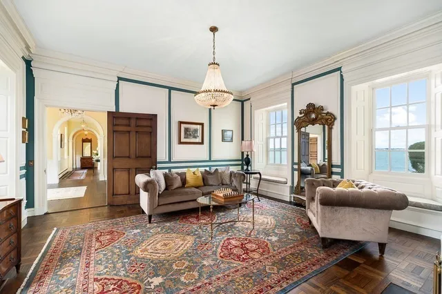 a living room with furniture and a chandelier