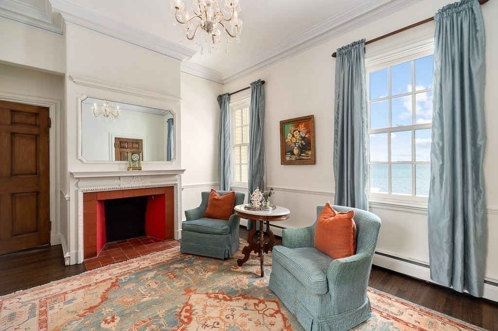 66 Ocean Street Nahant, MA 01908 - Photo 8 of 40 a living room with furniture windows and a fireplace