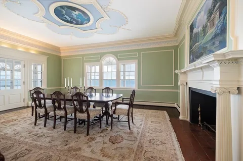 a dining room with furniture a floor to ceiling window and a fireplace