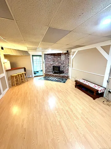a view of empty room with a fireplace and wooden floor
