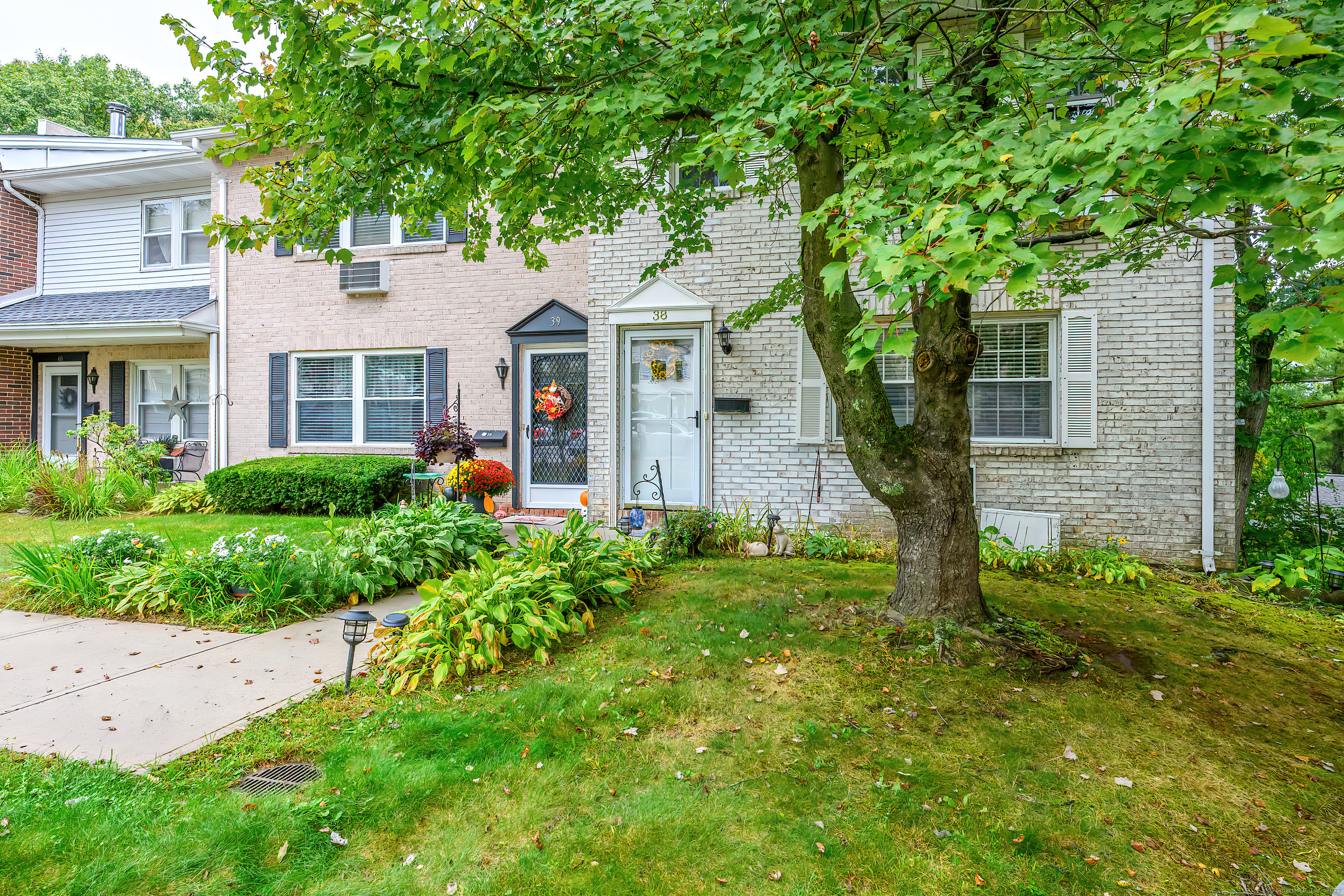 38 Surrey Lane, Unit 38 Torrington, CT 06790 - Photo 21 of 24 a front view of a house with garden