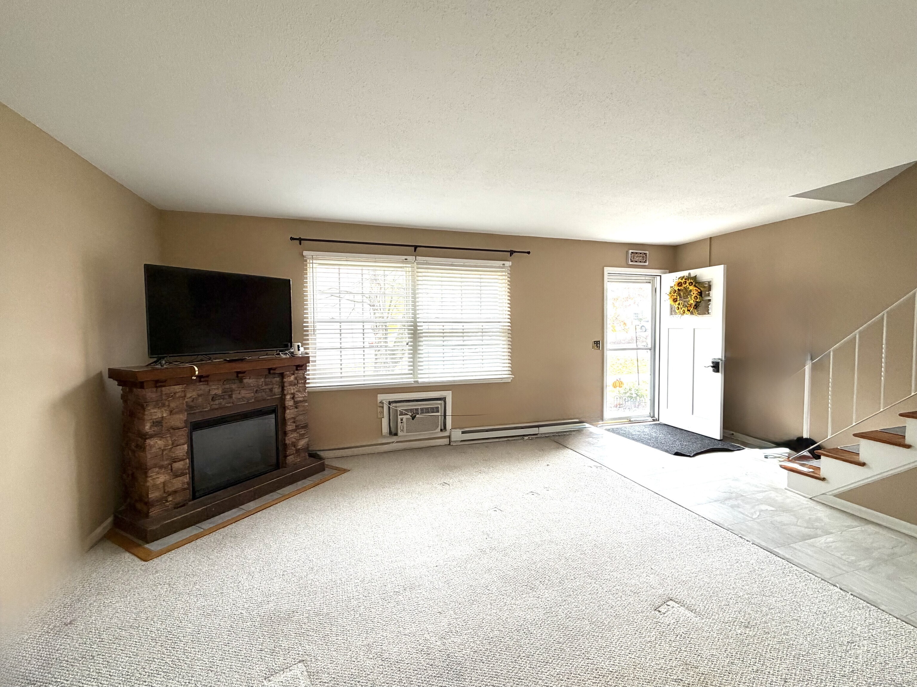 38 Surrey Lane, Unit 38 Torrington, CT 06790 - Photo 4 of 24 an empty room with windows and a flat screen tv