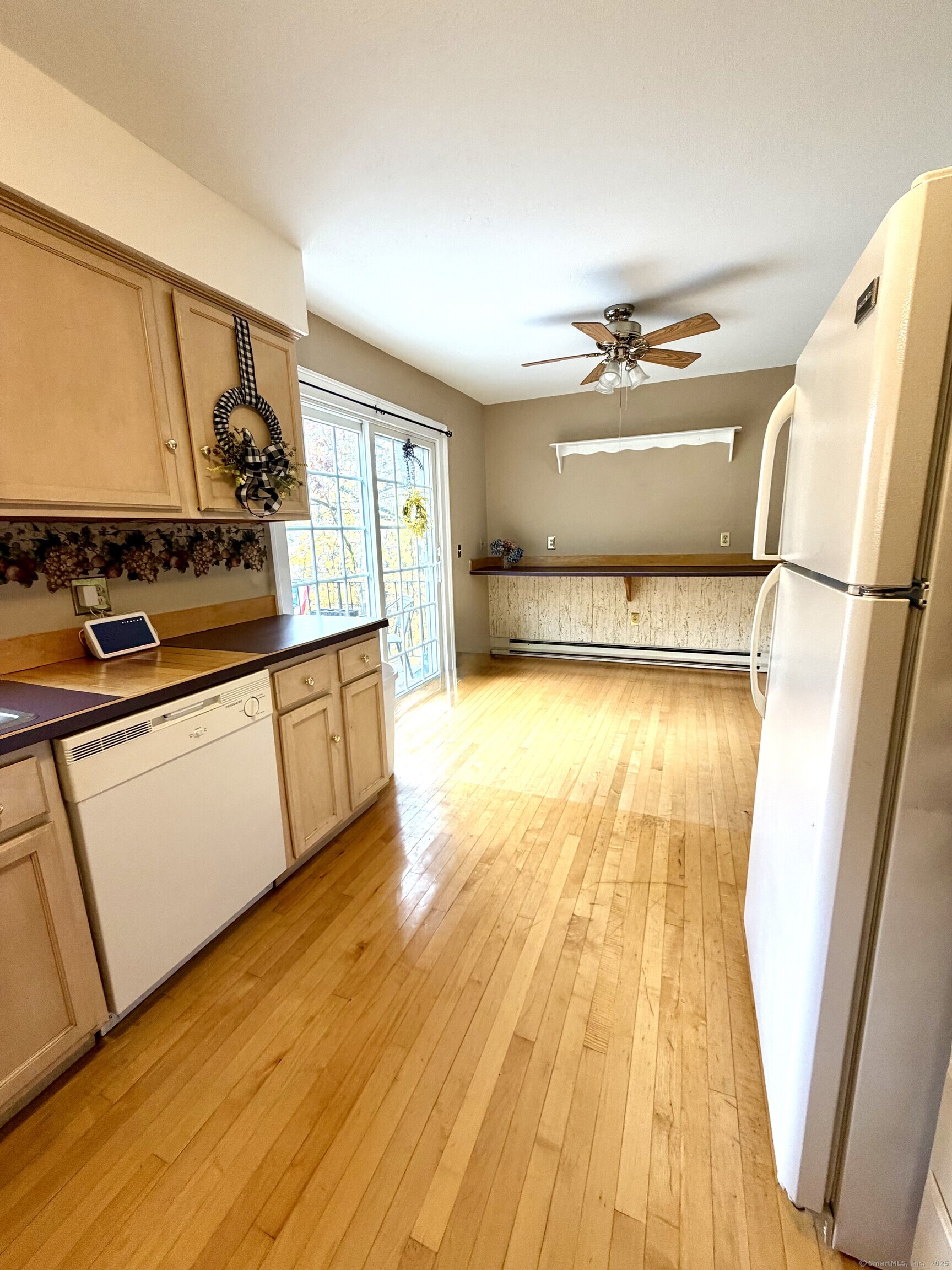 38 Surrey Lane, Unit 38 Torrington, CT 06790 - Photo 6 of 24 a kitchen with a sink and wooden floor