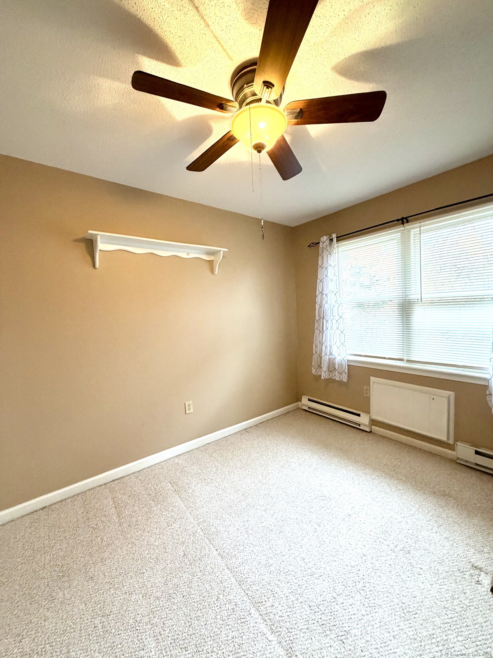 38 Surrey Lane, Unit 38 Torrington, CT 06790 - Photo 9 of 24 an empty room with windows and fan