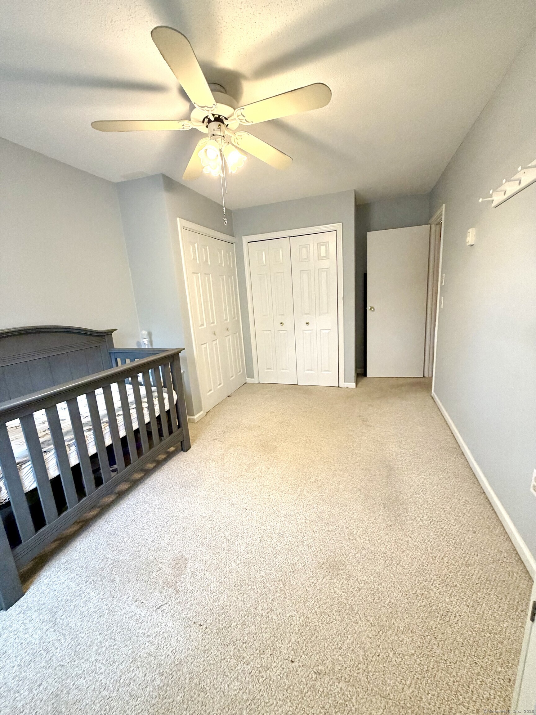 38 Surrey Lane, Unit 38 Torrington, CT 06790 - Photo 10 of 24 an empty room with windows and fan