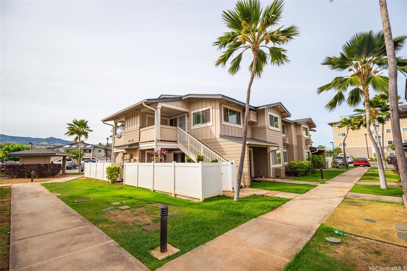 91-1029 Kamaaha Avenue, Unit 1204 Kapolei, HI 96707 - Photo 1 of 1 a front view of a house with yard and garden