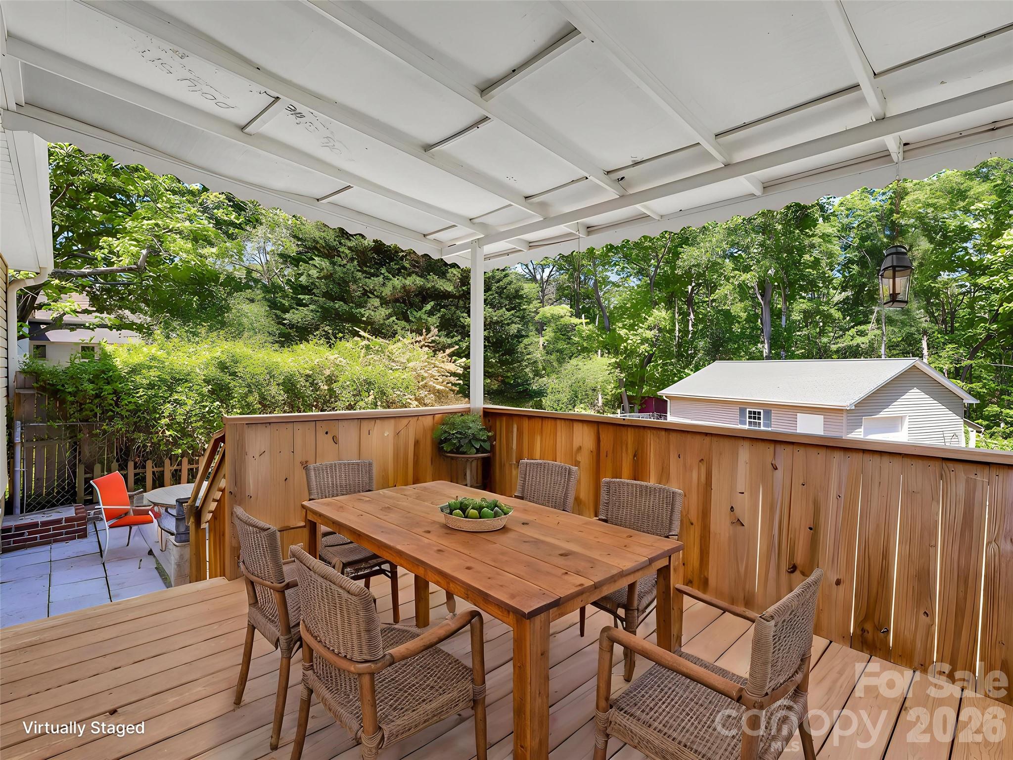 1249 Melvin Hill Road Campobello, SC 29322 - Photo 17 of 41 a view of a patio with table and chairs under an umbrella with a small yard