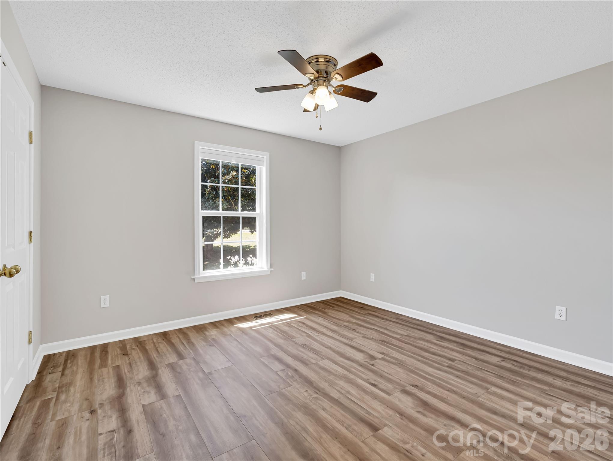 1249 Melvin Hill Road Campobello, SC 29322 - Photo 20 of 41 a view of an empty room with wooden floor and a window