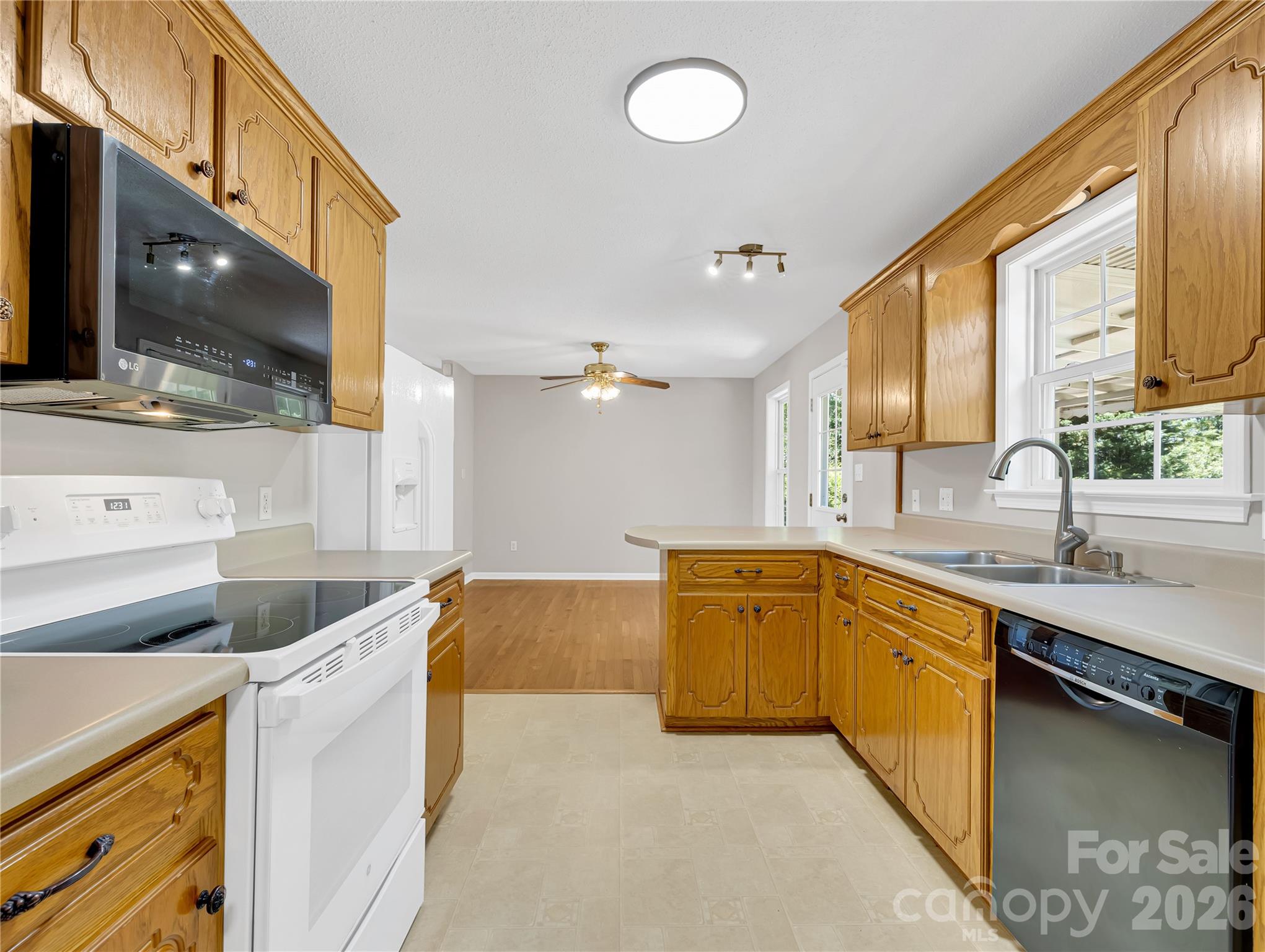 1249 Melvin Hill Road Campobello, SC 29322 - Photo 25 of 41 a large kitchen with stainless steel appliances granite countertop a sink and dishwasher a stove with wooden floor