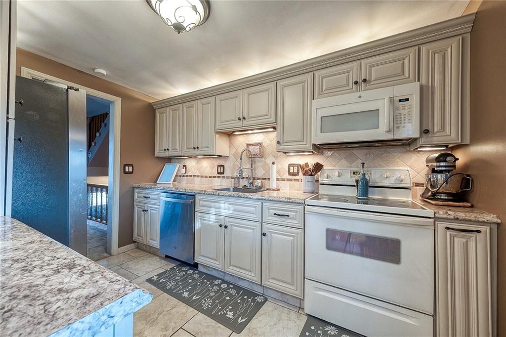 685 Blue Ridge Road Pittsburgh, PA 15239 - Photo 3 of 32 This kitchen has beautiful cream colored maple cabinetry, a stylish ceramic tile backsplash, stainless steel appliances and attractive countertops.