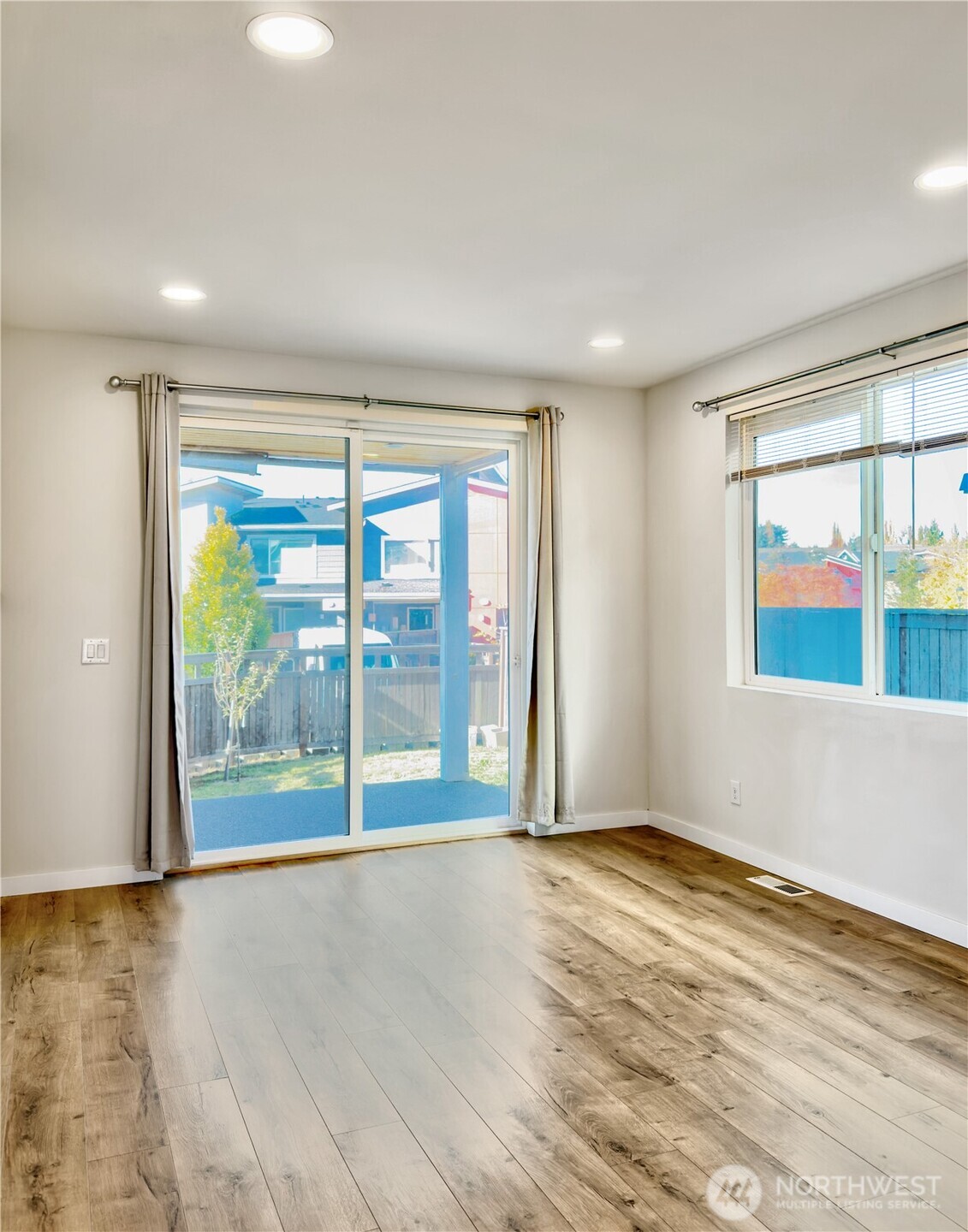 9849 6th Place Southwest Seattle, WA 98106 - Photo 13 of 21 an empty room with wooden floor and windows