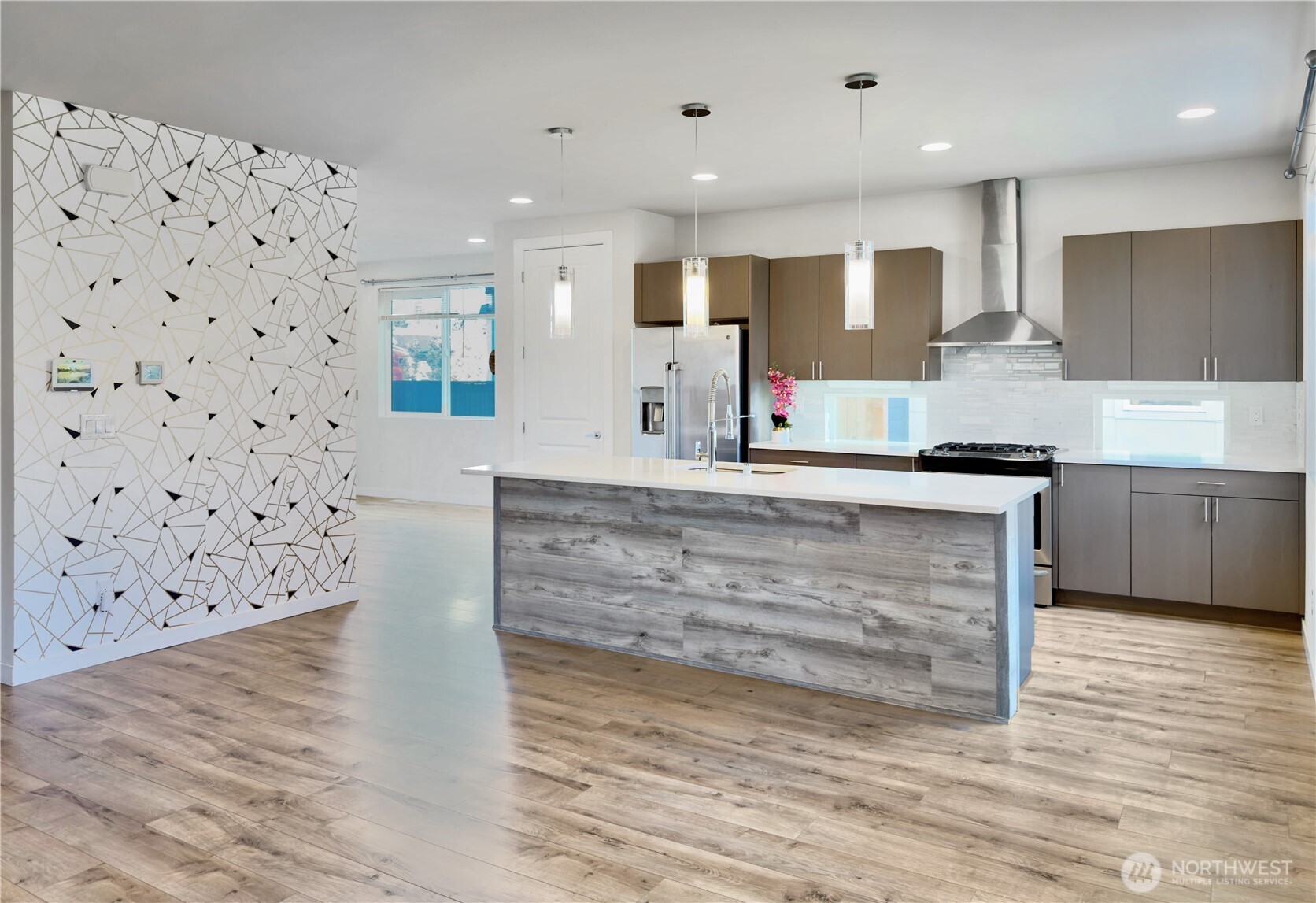 9849 6th Place Southwest Seattle, WA 98106 - Photo 6 of 21 a large kitchen with granite countertop a sink and a stove top oven