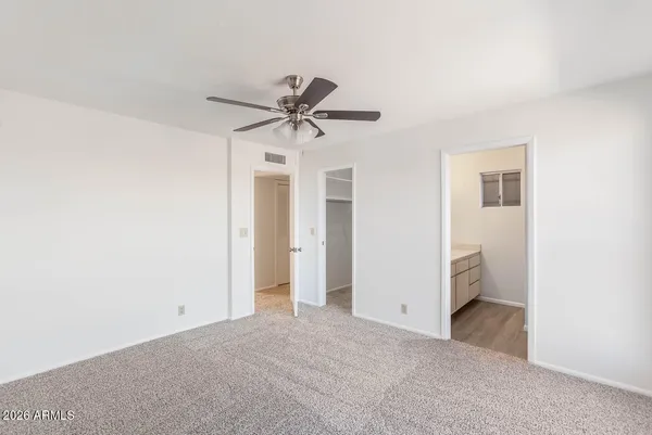 a view of a room with a ceiling fan