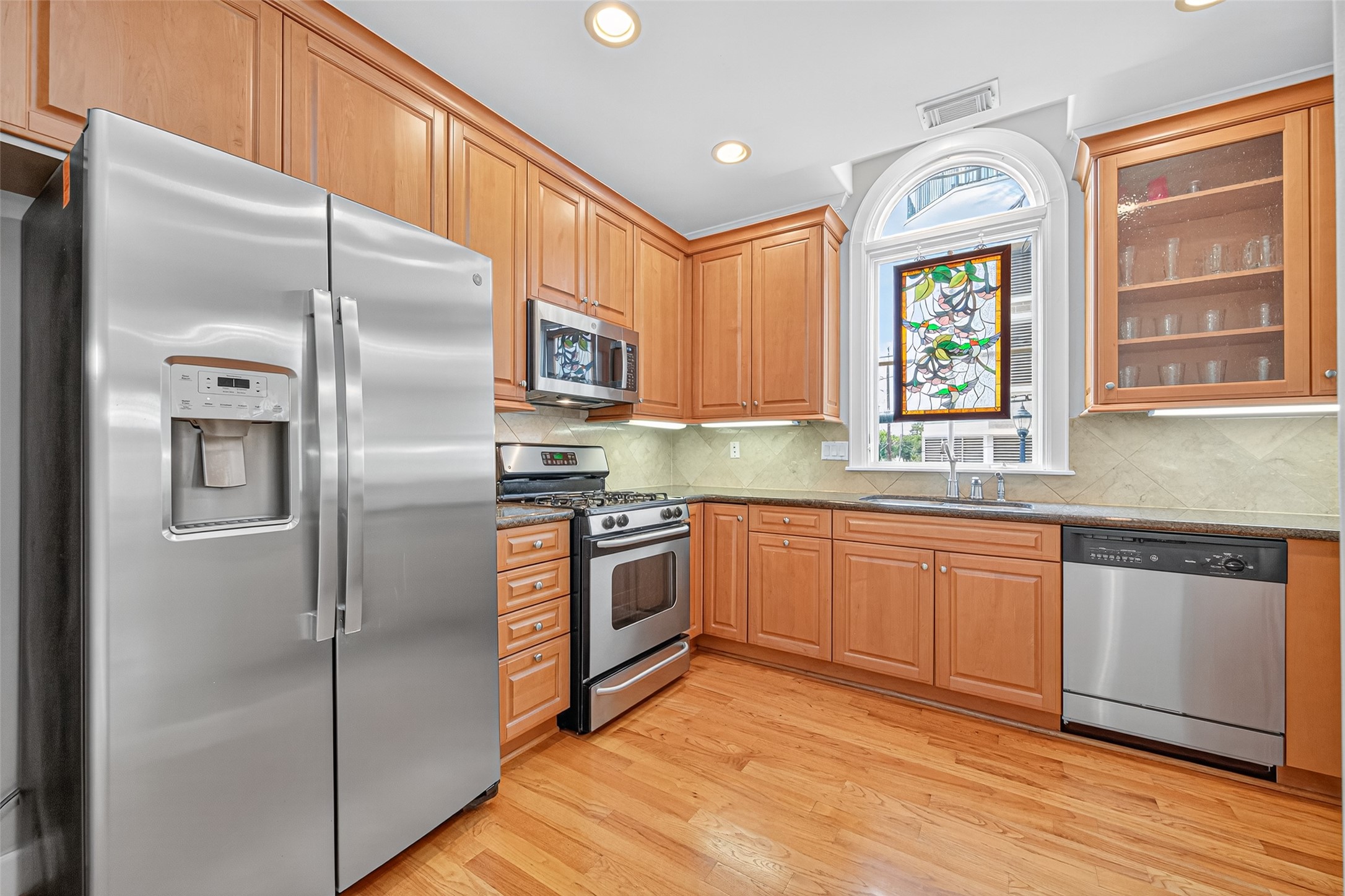 2624 Helena Street Houston, TX 77006 - Photo 13 of 33 a kitchen with stainless steel appliances granite countertop a refrigerator a sink a stove and cabinets