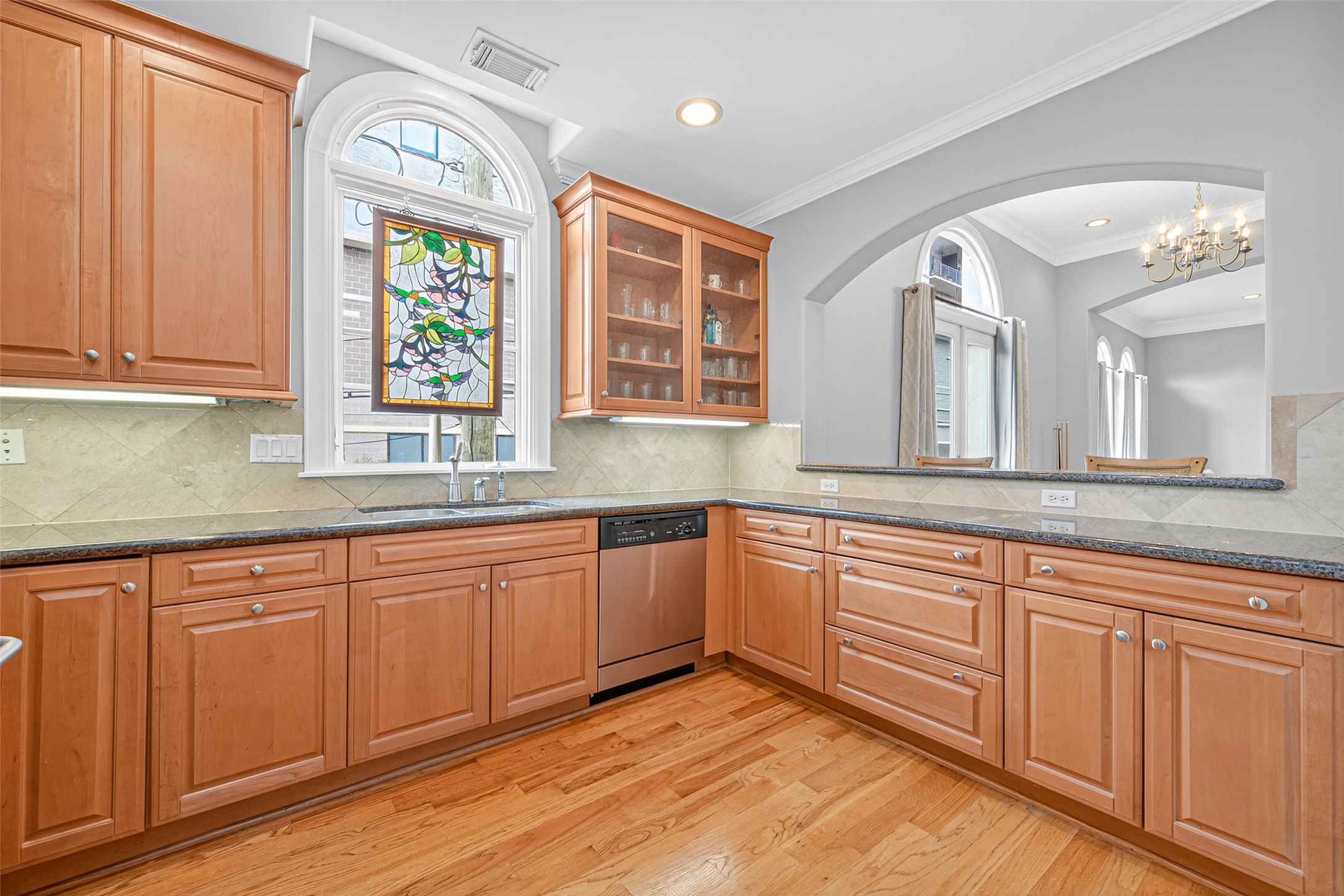 2624 Helena Street Houston, TX 77006 - Photo 14 of 33 a kitchen with wooden cabinets and sink