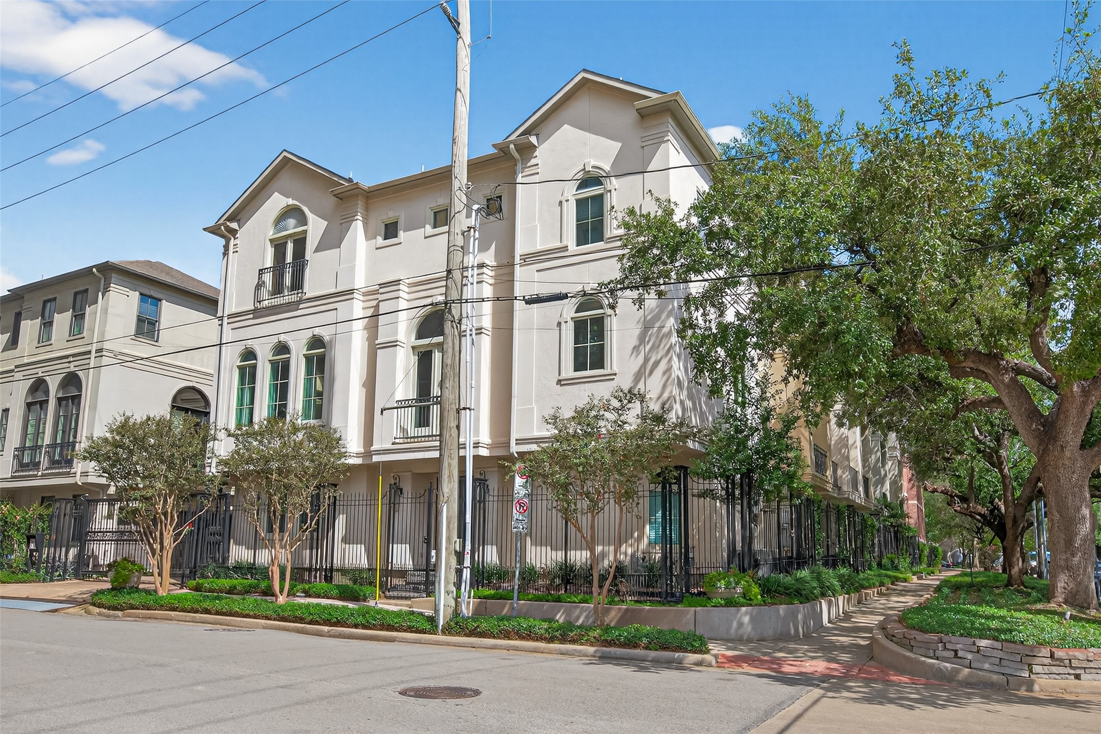 2624 Helena Street Houston, TX 77006 - Photo 2 of 33 a view of a white house with large windows and a yard