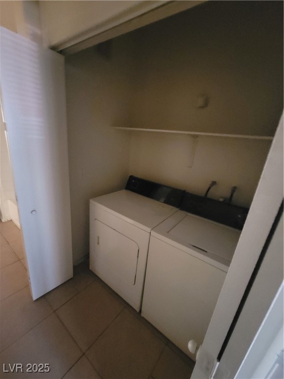 7413 West Russell Road, Unit 107 Las Vegas, NV 89113 - Photo 18 of 48 Washroom with washing machine and dryer and light tile patterned floors