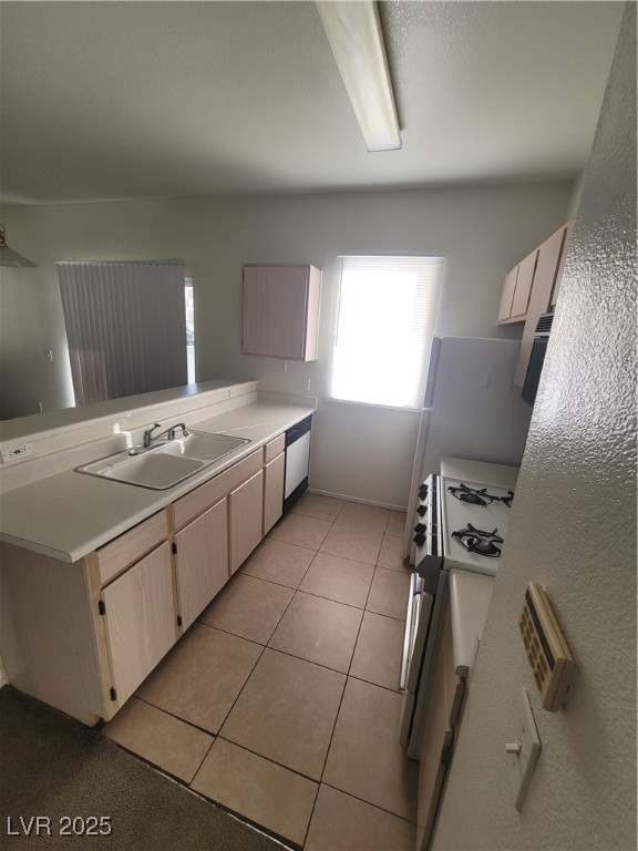 7413 West Russell Road, Unit 107 Las Vegas, NV 89113 - Photo 22 of 48 Kitchen with a sink, a peninsula, healthy amount of natural light, and light countertops