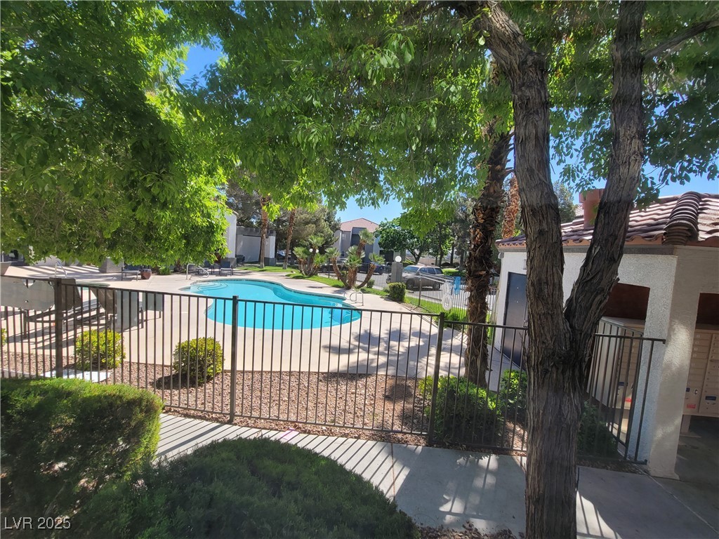 7413 West Russell Road, Unit 107 Las Vegas, NV 89113 - Photo 4 of 48 Community pool featuring a patio area