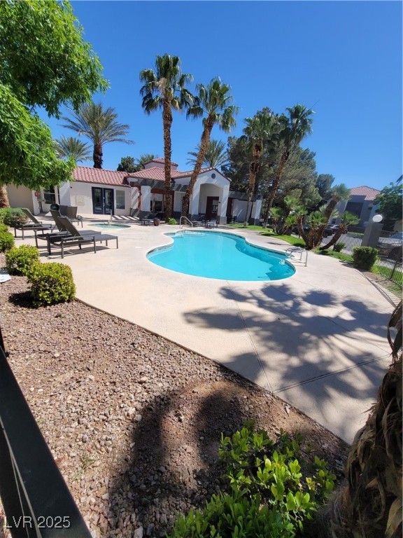 7413 West Russell Road, Unit 107 Las Vegas, NV 89113 - Photo 5 of 48 Community pool with a patio area